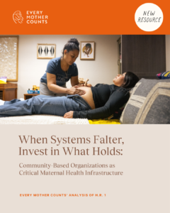 A pregnant woman, lying down, receives care from another woman